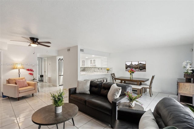 tiled living room with ceiling fan