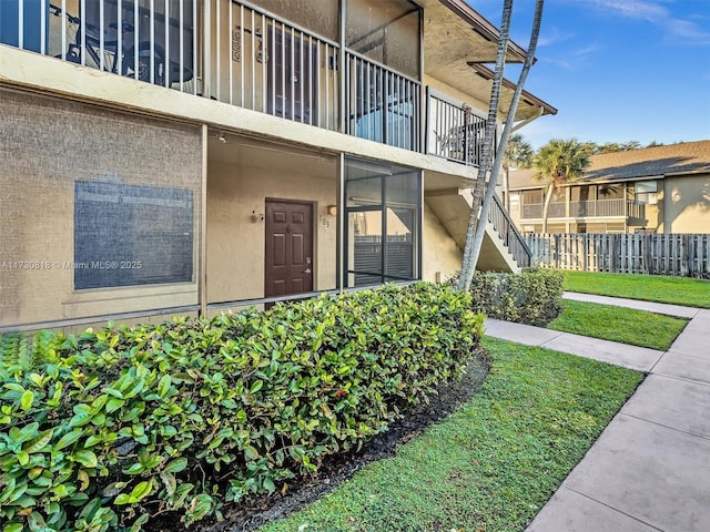 entrance to property with a lawn