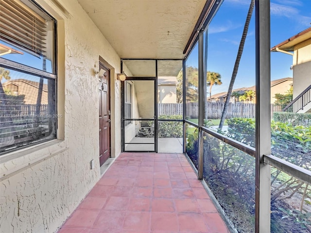 unfurnished sunroom with a wealth of natural light