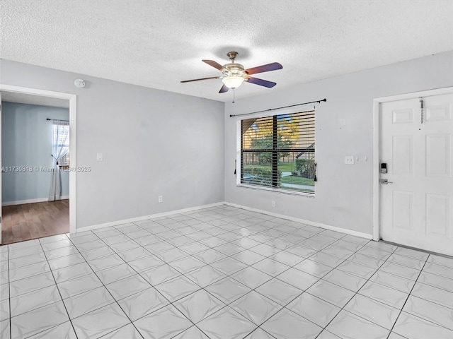 spare room featuring ceiling fan, a textured ceiling, and a healthy amount of sunlight