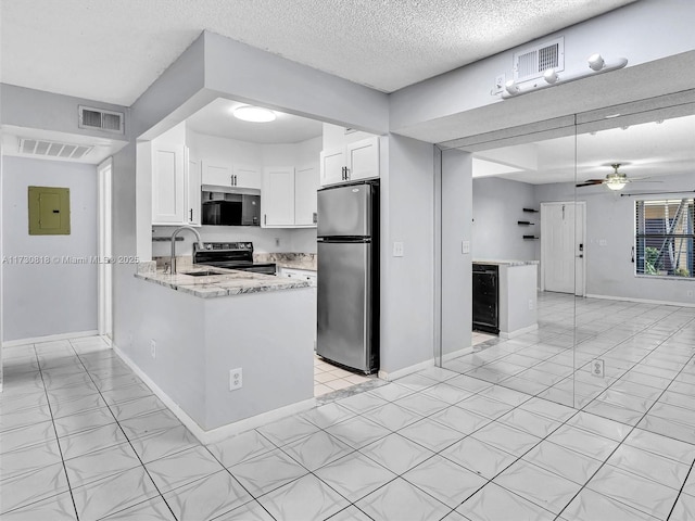 kitchen with a textured ceiling, appliances with stainless steel finishes, white cabinetry, sink, and kitchen peninsula