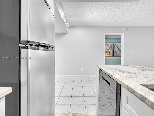 kitchen featuring white cabinetry, stainless steel fridge, a textured ceiling, and wine cooler