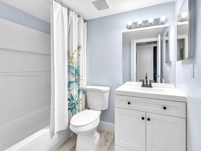 full bathroom featuring hardwood / wood-style floors, toilet, shower / bathtub combination with curtain, and vanity