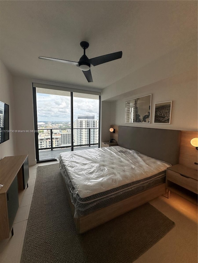 bedroom featuring access to exterior, ceiling fan, and light tile patterned flooring