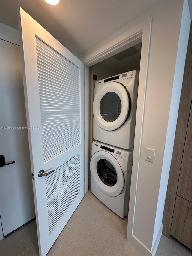 clothes washing area featuring stacked washer / dryer