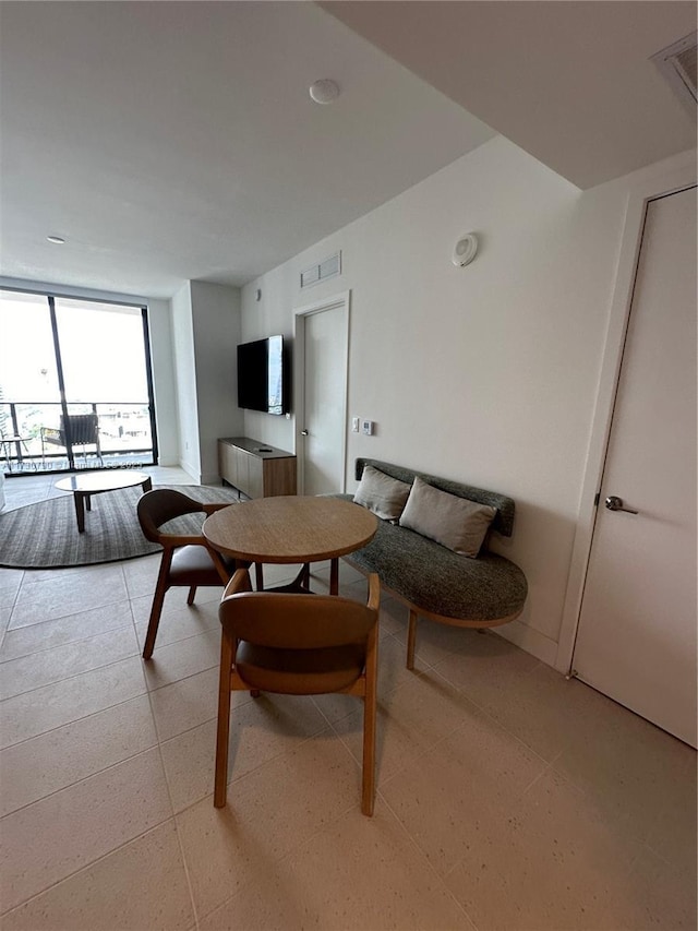 living room featuring floor to ceiling windows