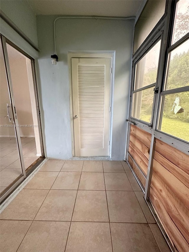 hall with tile patterned flooring