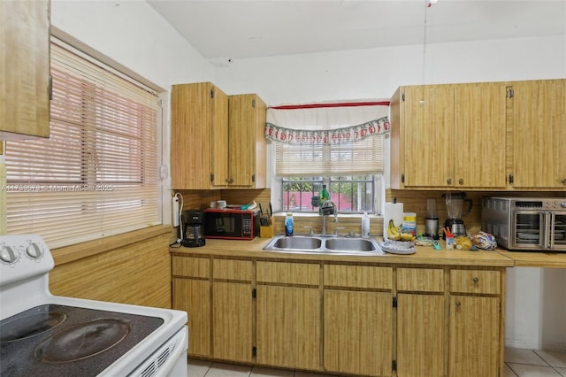 kitchen with sink, light tile patterned flooring, and white electric range oven