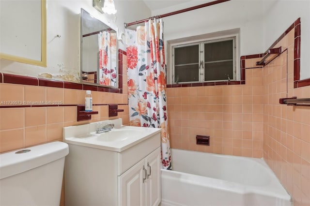 full bathroom featuring vanity, tile walls, shower / bathtub combination with curtain, and toilet