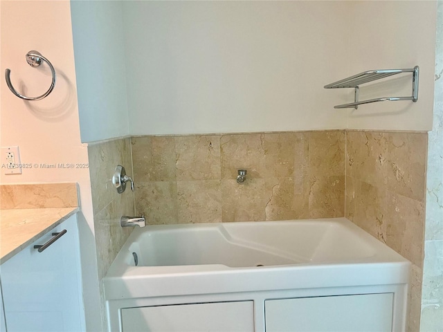 bathroom featuring vanity and a tub