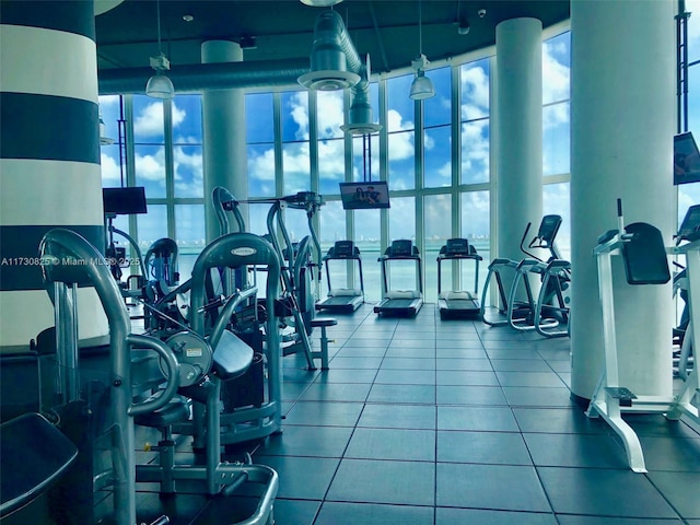 gym with a wall of windows and a high ceiling