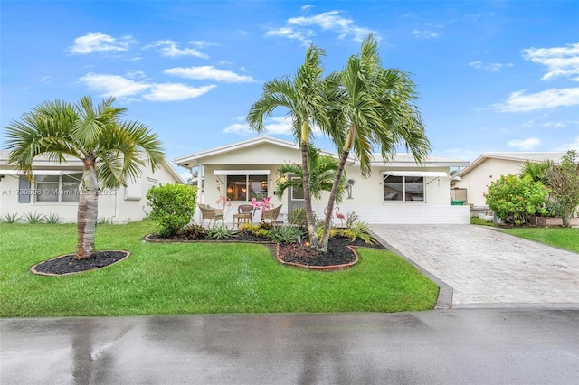 ranch-style house with a front yard and a porch