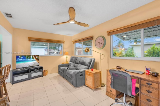 tiled office with ceiling fan and a textured ceiling