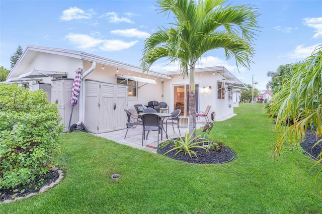 rear view of house featuring a yard