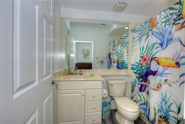 bathroom featuring toilet and vanity