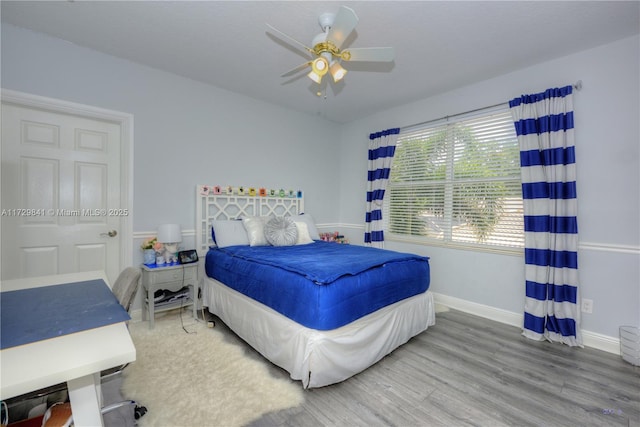 bedroom featuring hardwood / wood-style flooring and ceiling fan