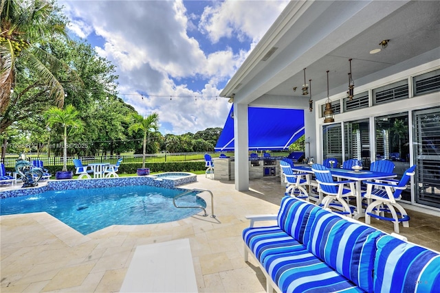 view of pool with an in ground hot tub, a patio area, and outdoor lounge area