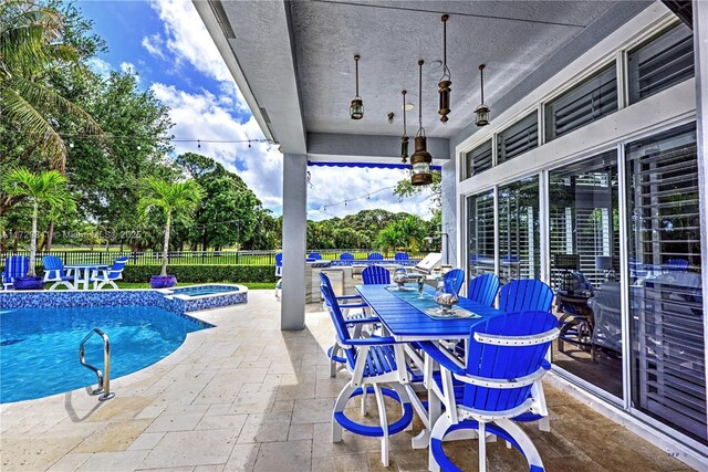 view of pool featuring an in ground hot tub and a patio area