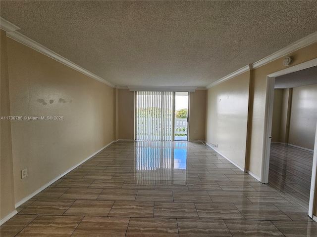 spare room with a wall of windows, crown molding, and a textured ceiling