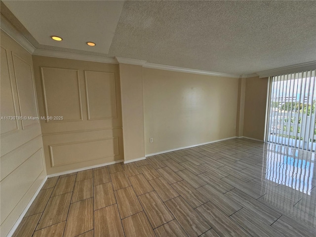 spare room with crown molding and a textured ceiling