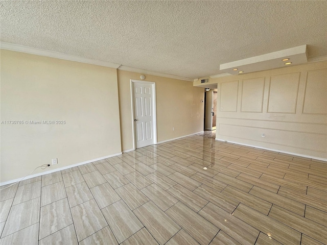 empty room with a textured ceiling and ornamental molding