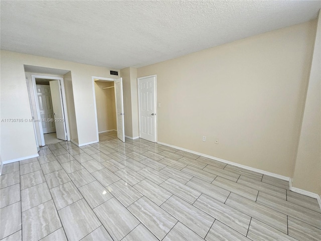 unfurnished bedroom featuring a textured ceiling