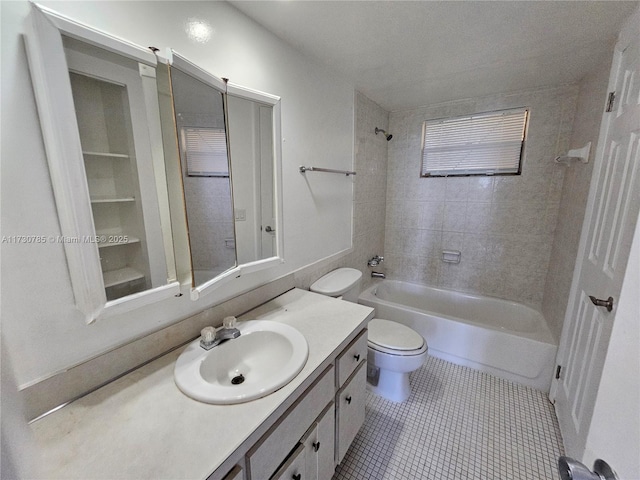 full bathroom with vanity, toilet, tile patterned flooring, and tiled shower / bath combo