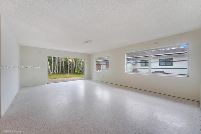 spare room with a textured ceiling