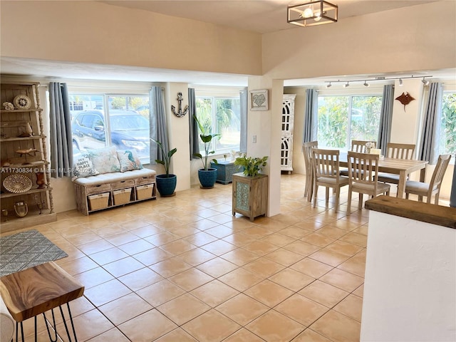 interior space featuring light tile patterned floors and an inviting chandelier