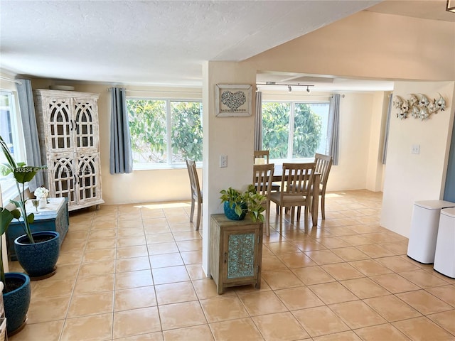 tiled dining room with a textured ceiling