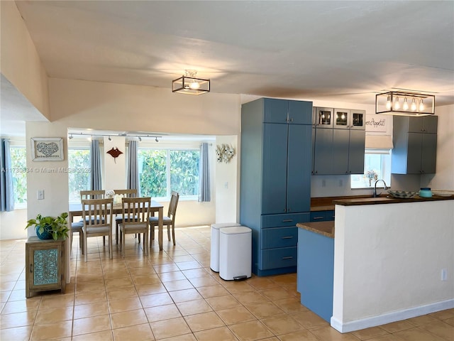 kitchen featuring blue cabinets and light tile patterned floors