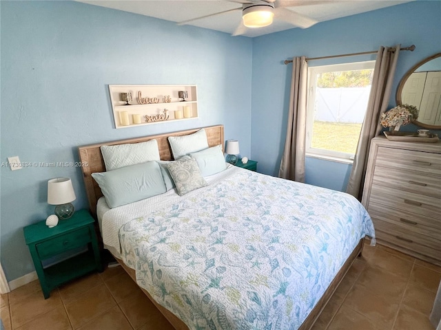 bedroom featuring dark tile patterned floors and ceiling fan