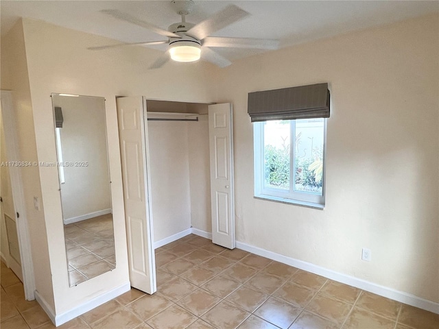 unfurnished bedroom with ceiling fan and a closet