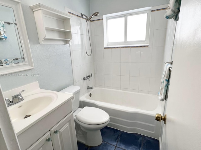 full bathroom with vanity, tiled shower / bath combo, tile patterned floors, and toilet