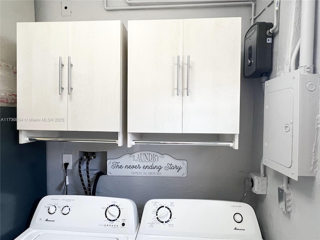 laundry room with washer and clothes dryer and cabinets