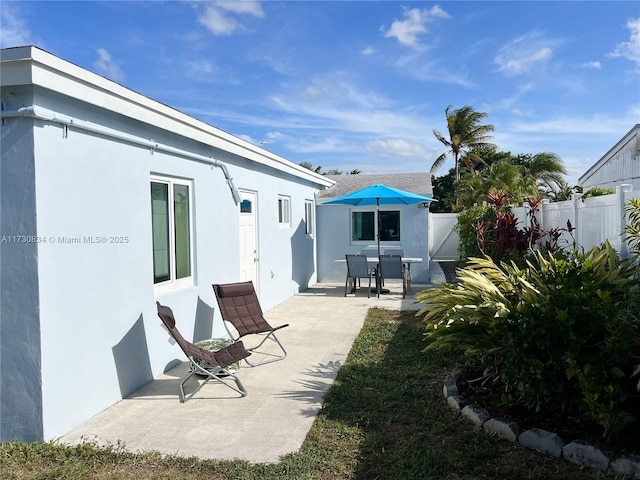 back of property with a patio