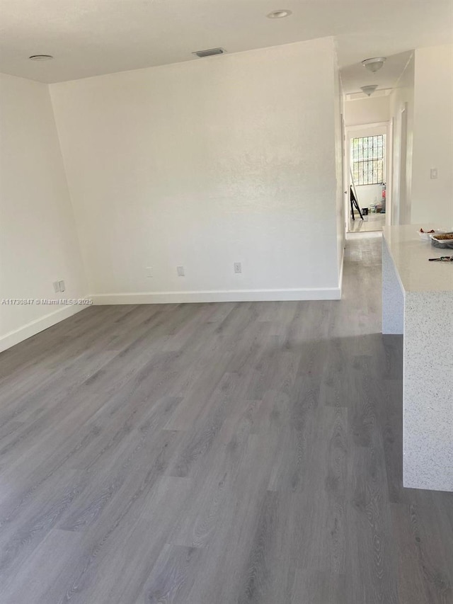 unfurnished room with hardwood / wood-style floors