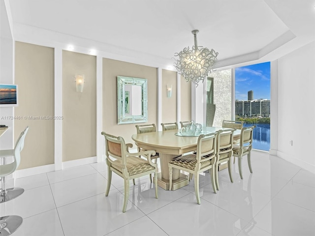 tiled dining space featuring a notable chandelier