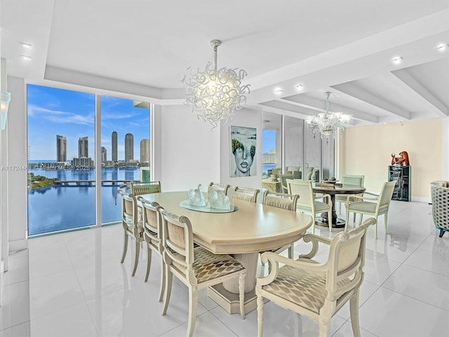 dining space featuring a tray ceiling, a water view, a chandelier, floor to ceiling windows, and light tile patterned floors