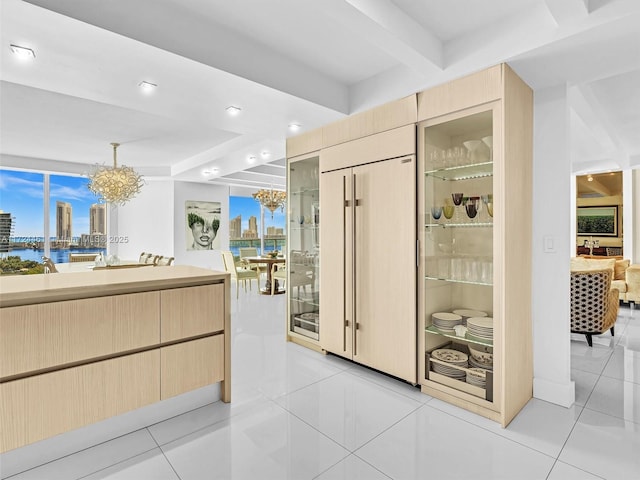 interior space featuring light tile patterned floors and a notable chandelier