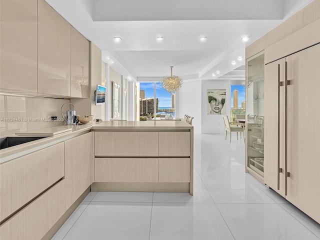 kitchen with kitchen peninsula, light brown cabinets, decorative backsplash, and light tile patterned flooring