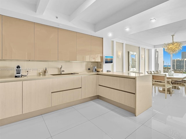 kitchen featuring sink, light brown cabinets, kitchen peninsula, and light tile patterned floors