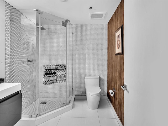 bathroom with toilet, tile patterned flooring, and an enclosed shower