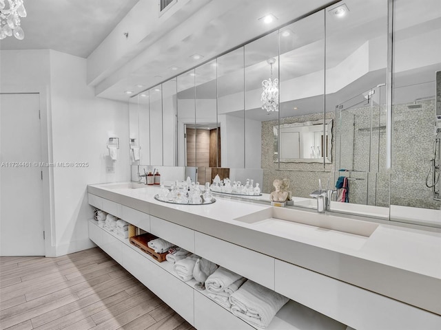 bathroom featuring vanity and a shower with door