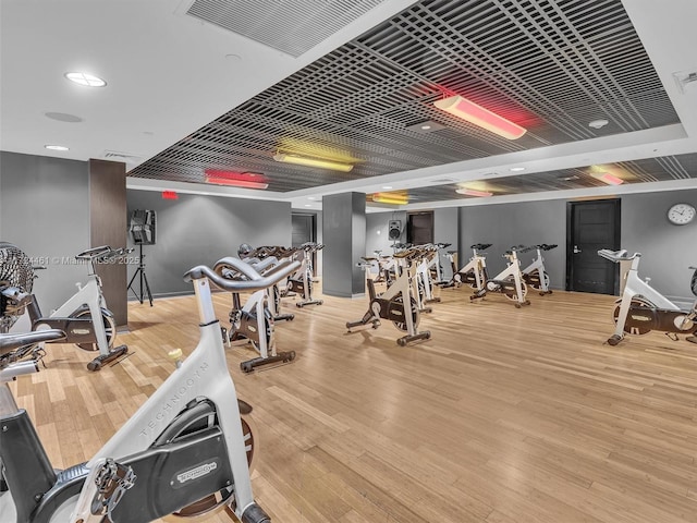 exercise room with hardwood / wood-style floors