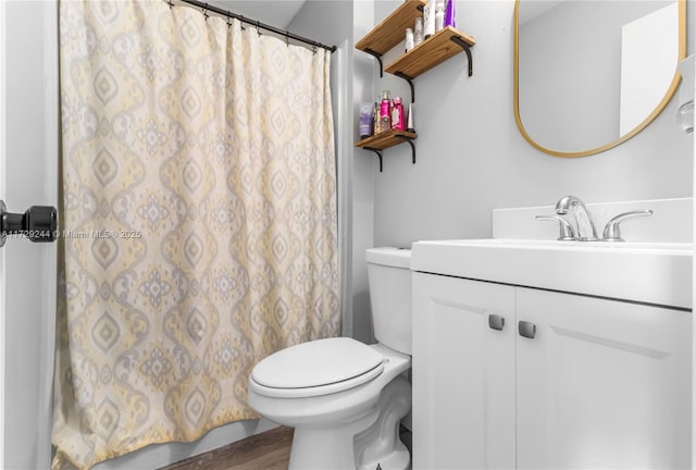 bathroom with vanity, toilet, and hardwood / wood-style flooring