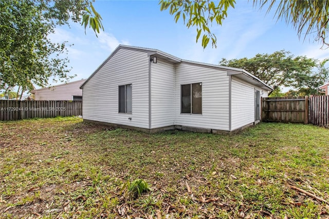 back of house with a yard