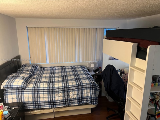 bedroom featuring hardwood / wood-style flooring and a textured ceiling