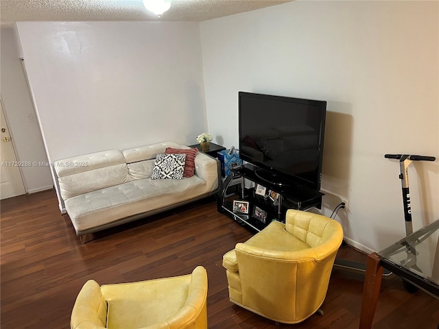 living room with dark wood-type flooring and a textured ceiling