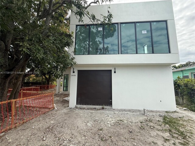 back of house featuring a garage